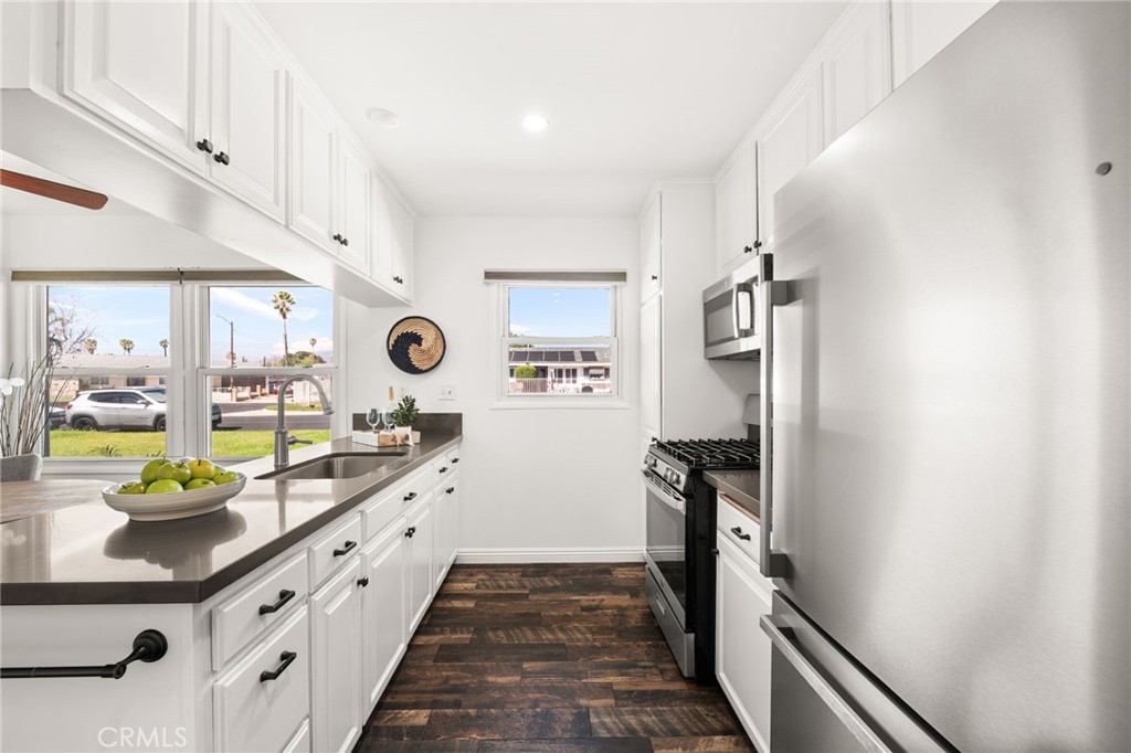 6661 Yucca Avenue Rialto, CA 92376 - Photo 9 of 44 a kitchen with stainless steel appliances granite countertop a refrigerator and stove