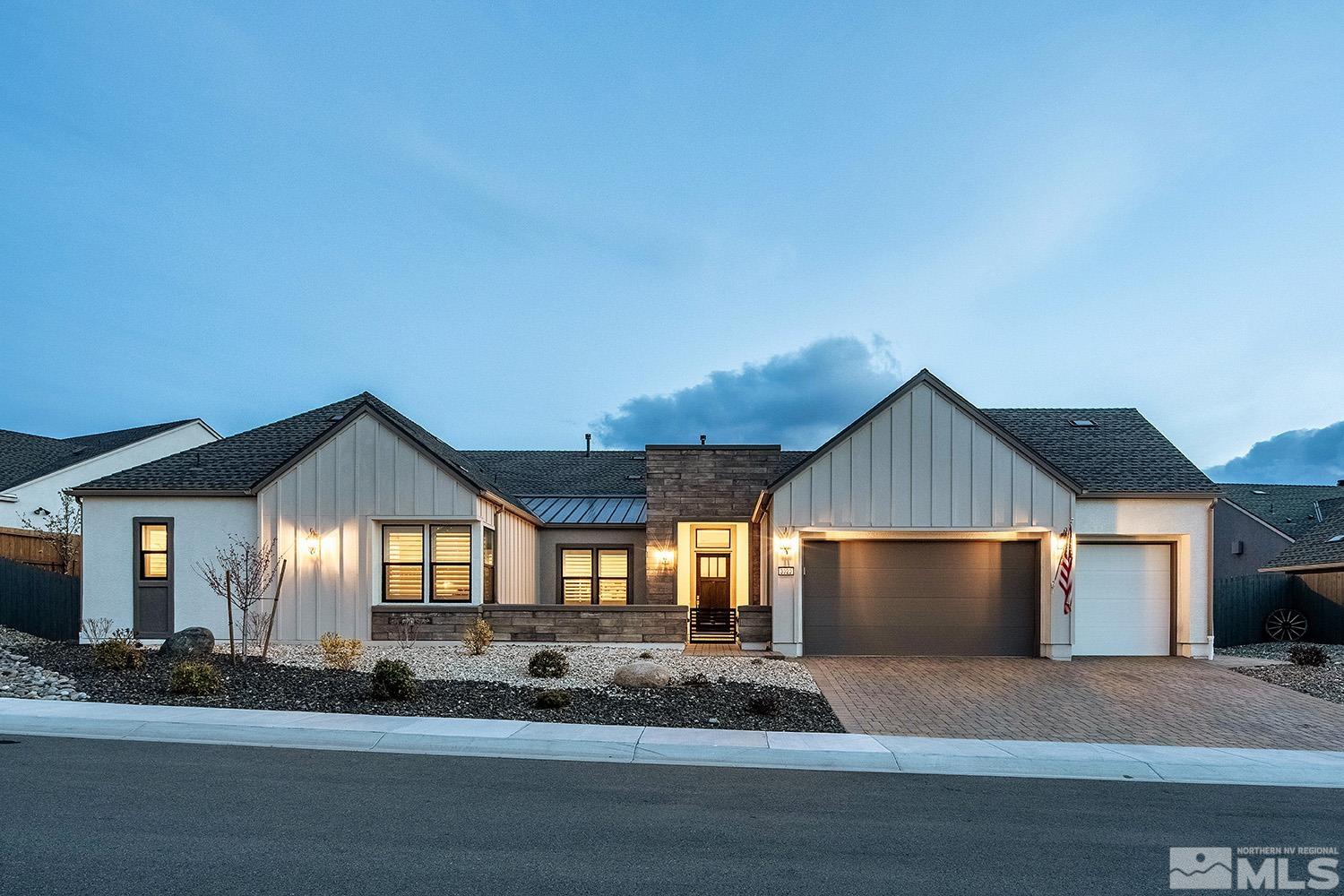 a view of a house with a yard and large tree