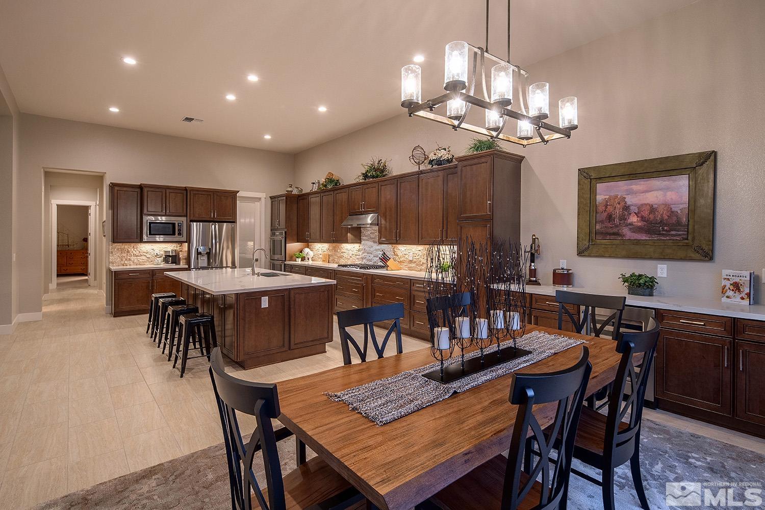 3020 Feathertop Drive Reno, NV 89521 - Photo 16 of 40 a view of a dining room with furniture a chandelier and wooden floor