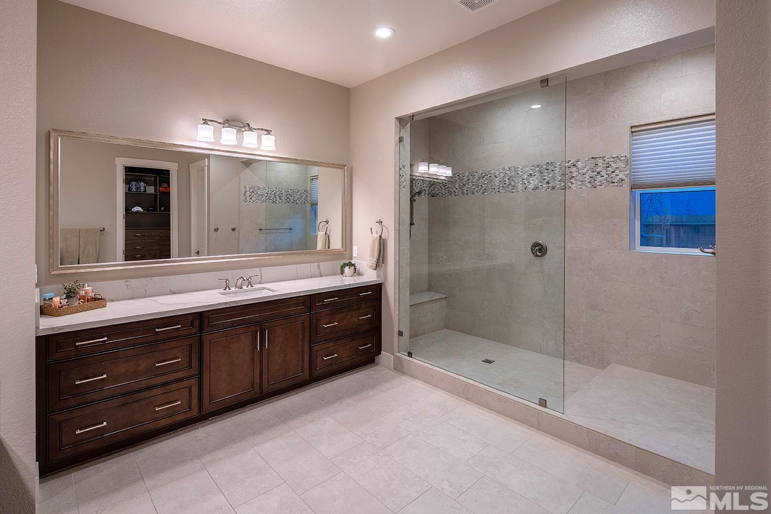 3020 Feathertop Drive Reno, NV 89521 - Photo 21 of 40 a spacious bathroom with a granite countertop sink mirror and shower