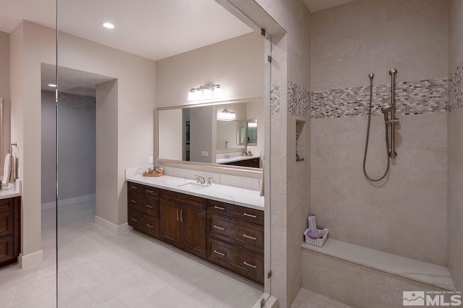 3020 Feathertop Drive Reno, NV 89521 - Photo 22 of 40 a bathroom with a double vanity sink a toilet a mirror and shower
