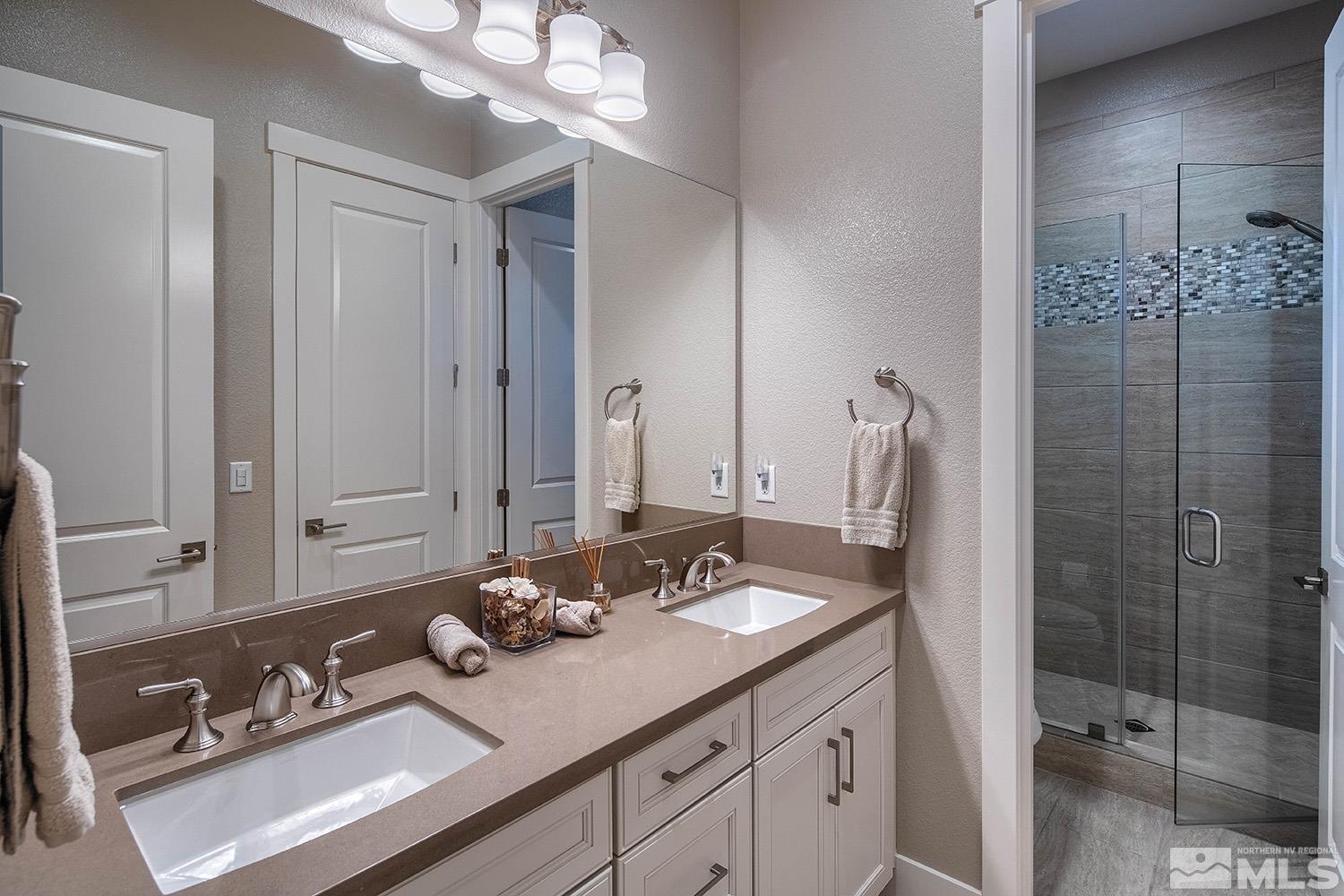 3020 Feathertop Drive Reno, NV 89521 - Photo 26 of 40 a bathroom with a sink double vanity and a mirror