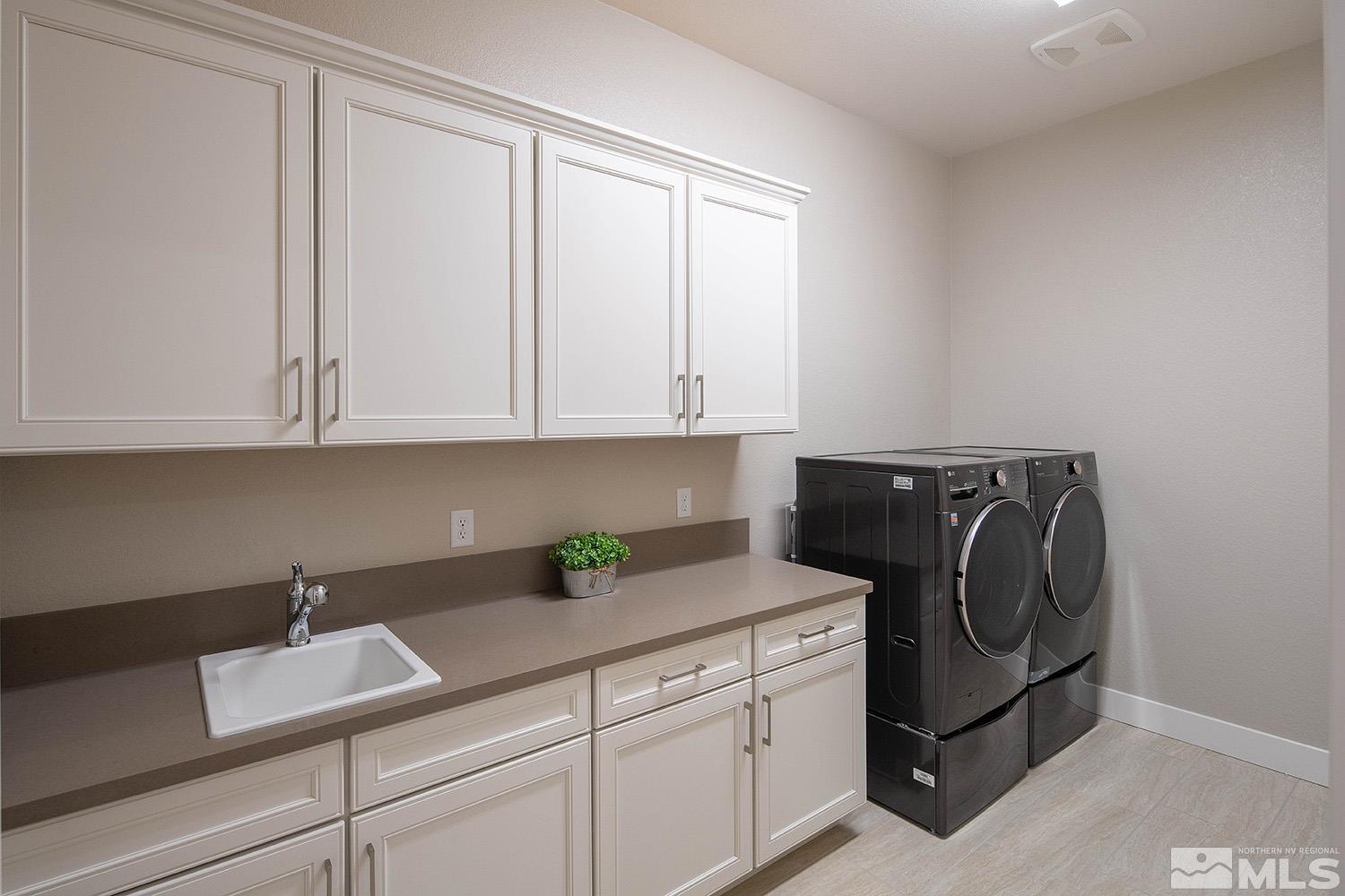 3020 Feathertop Drive Reno, NV 89521 - Photo 28 of 40 a utility room with cabinets washer and dryer