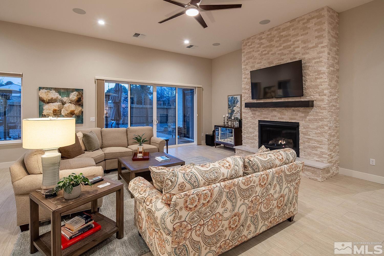 3020 Feathertop Drive Reno, NV 89521 - Photo 6 of 40 a living room with furniture fireplace and a flat screen tv