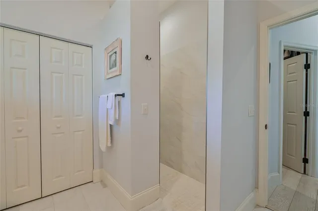 a dining room with furniture a chandelier and kitchen view