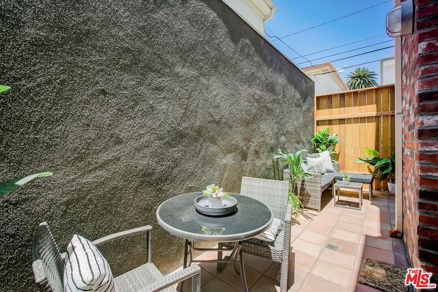 a backyard of a house with table and chairs