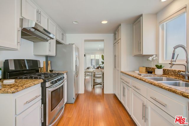 a kitchen with a stove a sink and a refrigerator