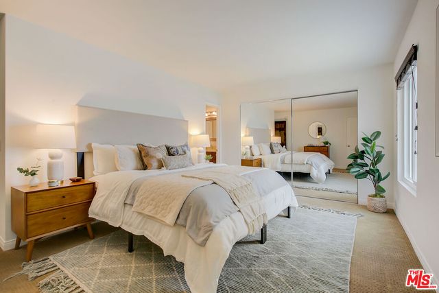 a spacious bedroom with a bed and a couch