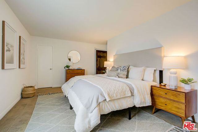 a bed room with a bed and a lamp