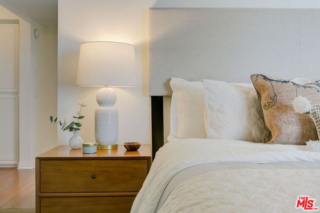 a bedroom with a bed and mirror