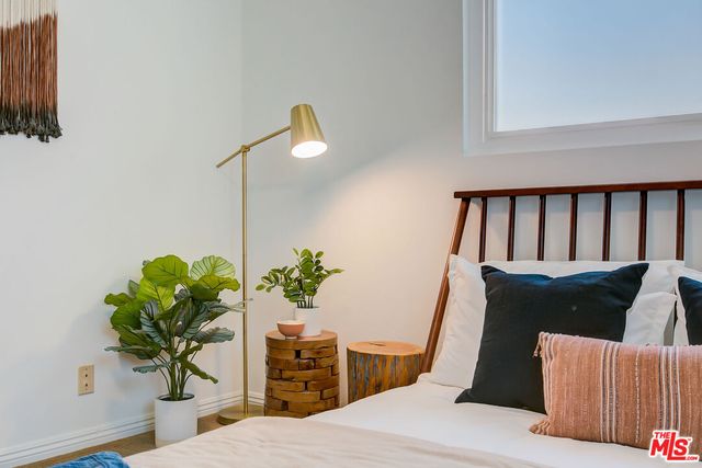 a living room with furniture flowerpot and a potted plant