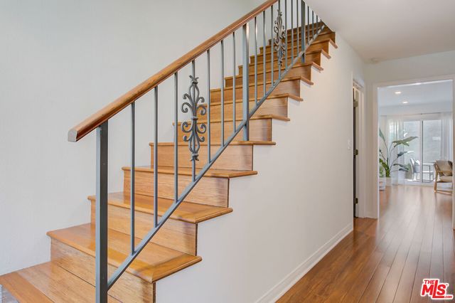 a view of entryway with wooden floor and stairs
