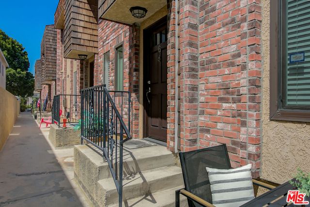 a view of a patio with a table and chairs and potted plants