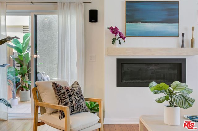 a living room with furniture potted plant and a fireplace