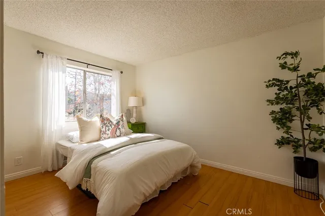 a bedroom with a bed and a potted plant