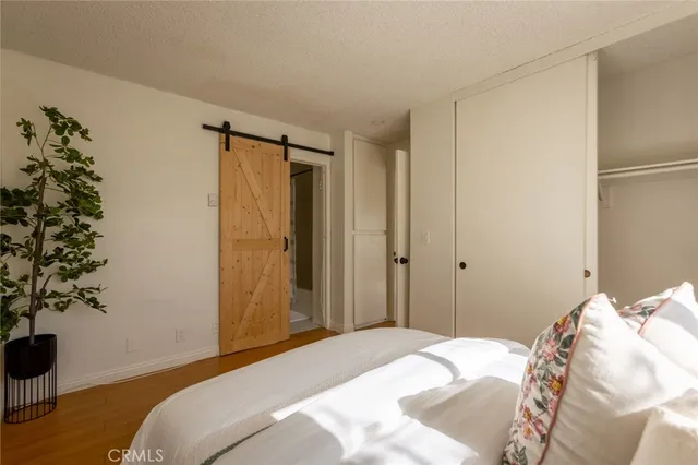 a bedroom with a bed and a plant