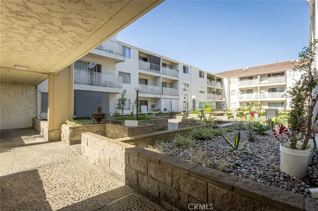 a view of a patio with table and chairs and potted plants