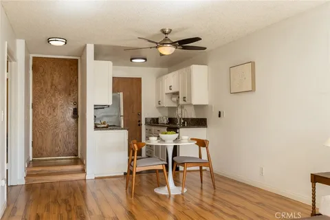 a view of a dining room with furniture and wooden floor