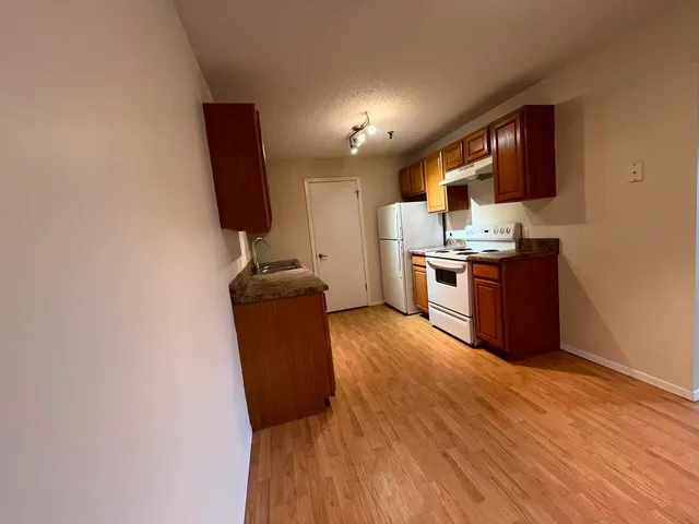 a kitchen with stainless steel appliances granite countertop a stove top oven a sink and dishwasher