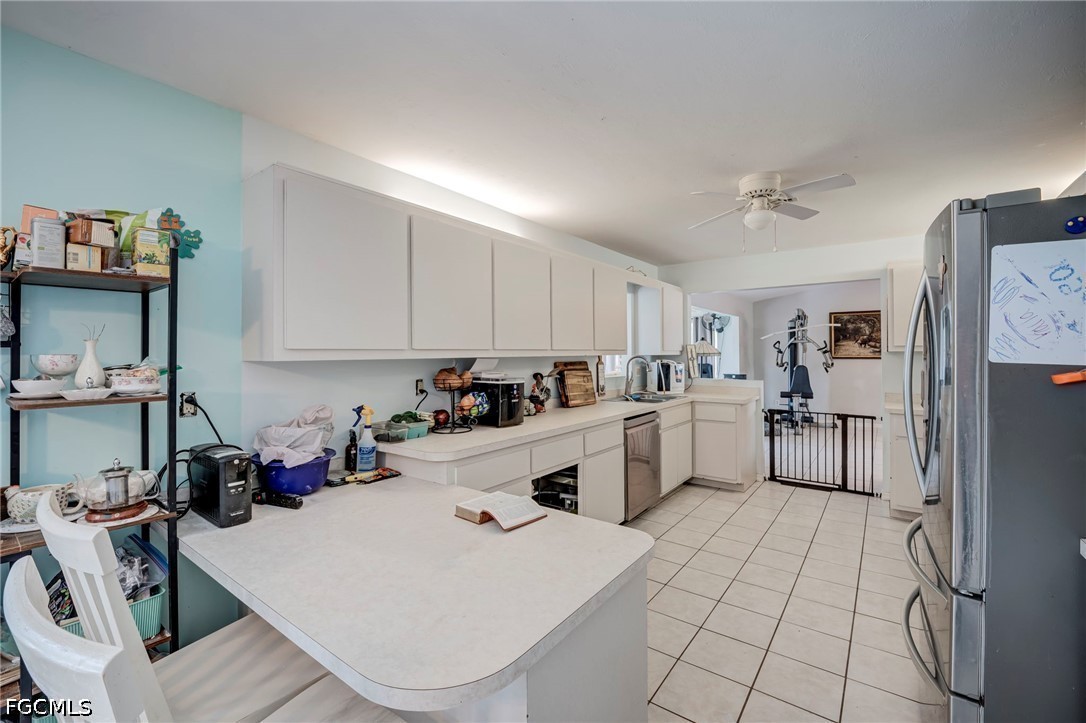 4110 East 23rd Street Alva, FL 33920 - Photo 11 of 38 a kitchen with a sink a stove and cabinets
