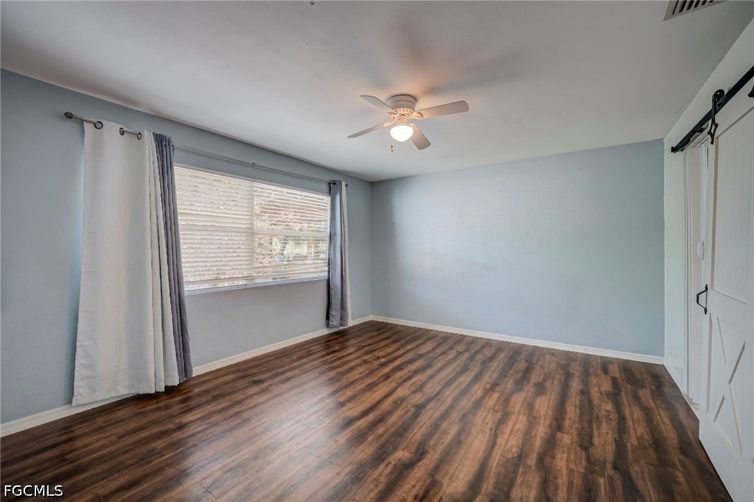 4110 East 23rd Street Alva, FL 33920 - Photo 13 of 38 a view of an empty room with a window and wooden floor