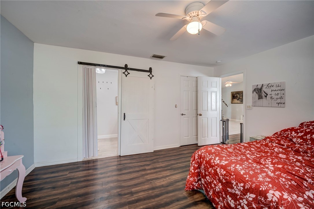 4110 East 23rd Street Alva, FL 33920 - Photo 14 of 38 a bedroom with a bed and a chandelier