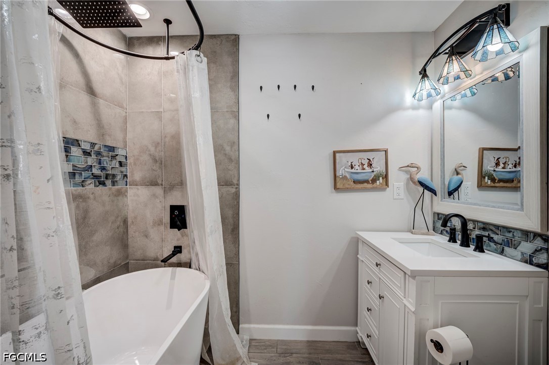 4110 East 23rd Street Alva, FL 33920 - Photo 15 of 38 a bathroom with a sink a toilet a mirror a vanity and shower