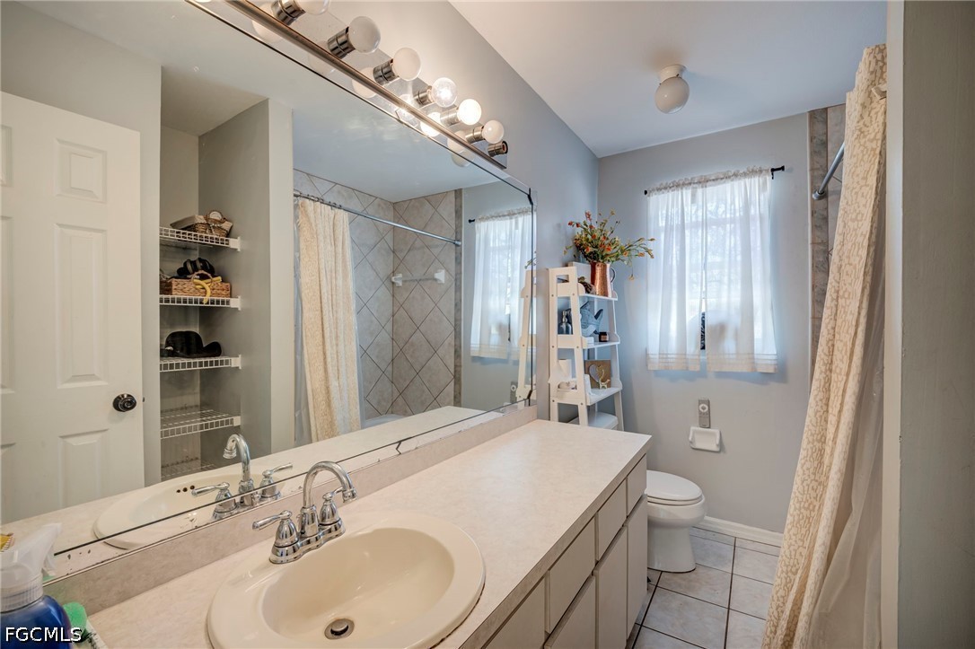 4110 East 23rd Street Alva, FL 33920 - Photo 17 of 38 a bathroom with a sink toilet and shower