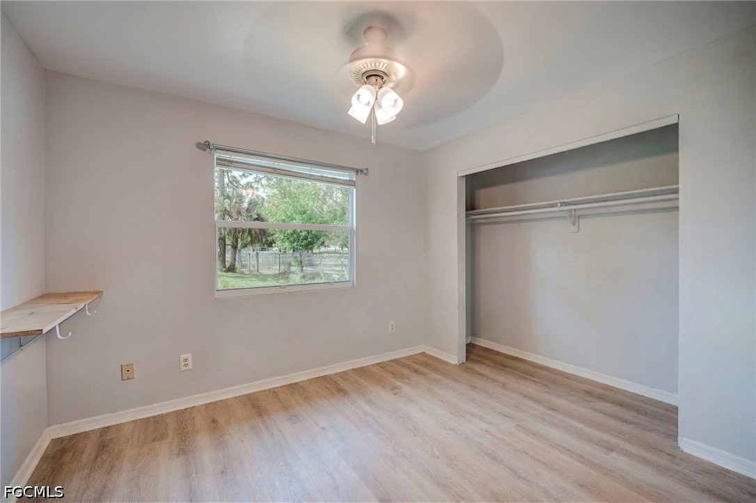 4110 East 23rd Street Alva, FL 33920 - Photo 18 of 38 wooden floor in an empty room with a window