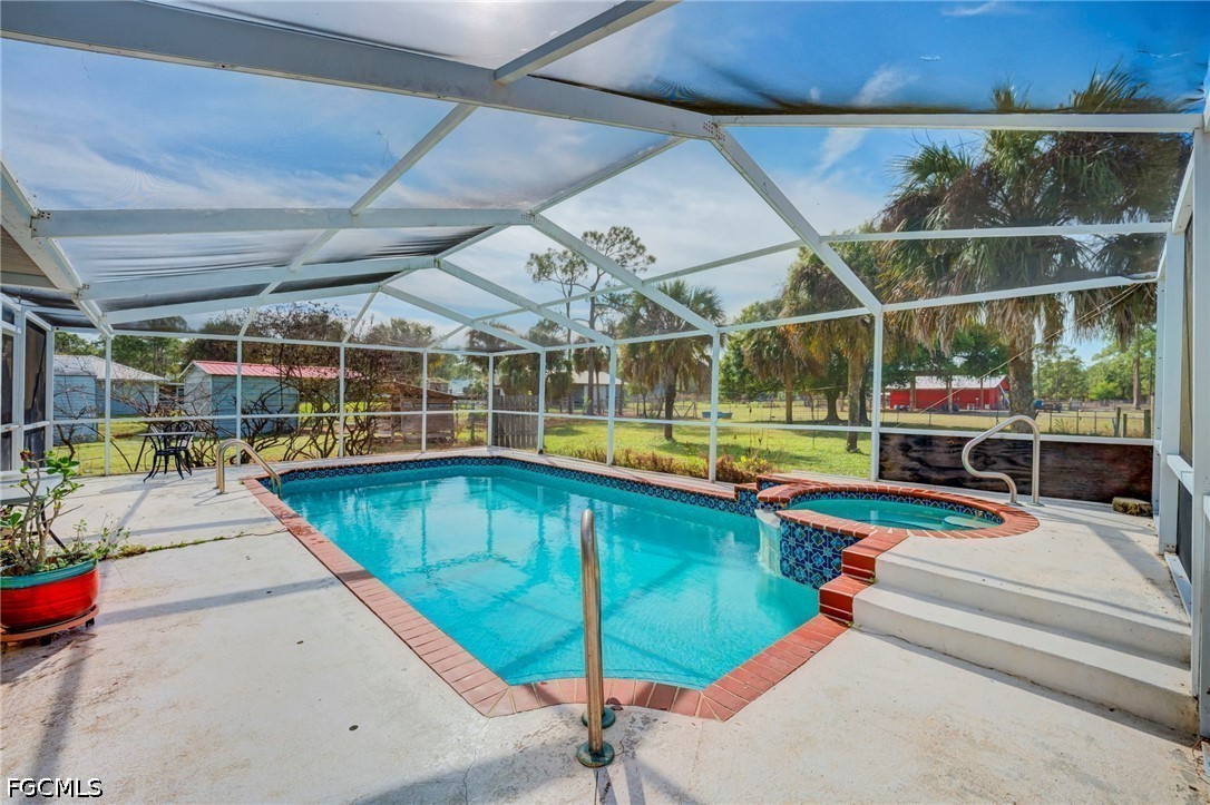 4110 East 23rd Street Alva, FL 33920 - Photo 2 of 38 a view of a swimming pool with a patio