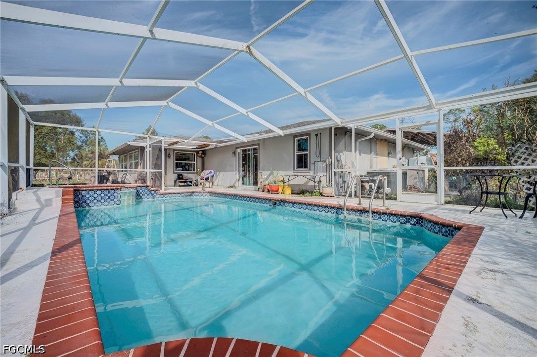 4110 East 23rd Street Alva, FL 33920 - Photo 21 of 38 a view of a swimming pool with a patio