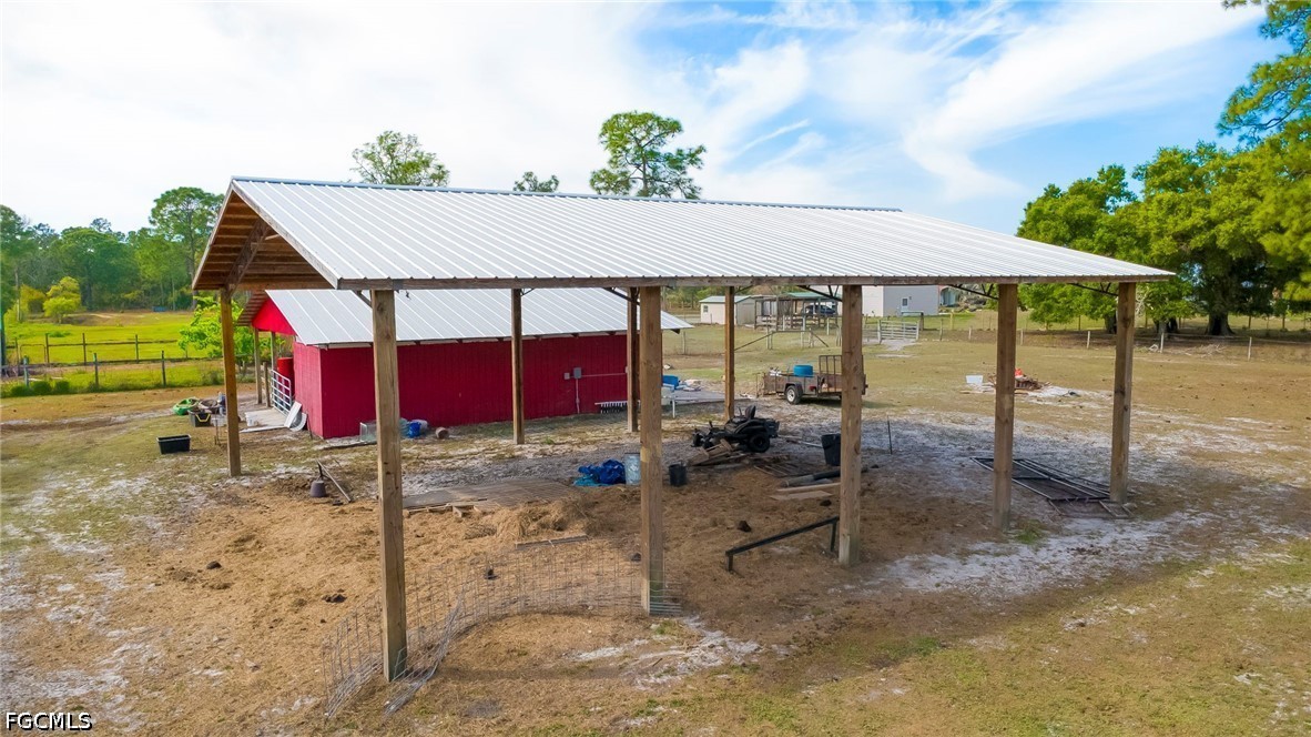 4110 East 23rd Street Alva, FL 33920 - Photo 25 of 38 a view of patio with chairs and table under an umbrella