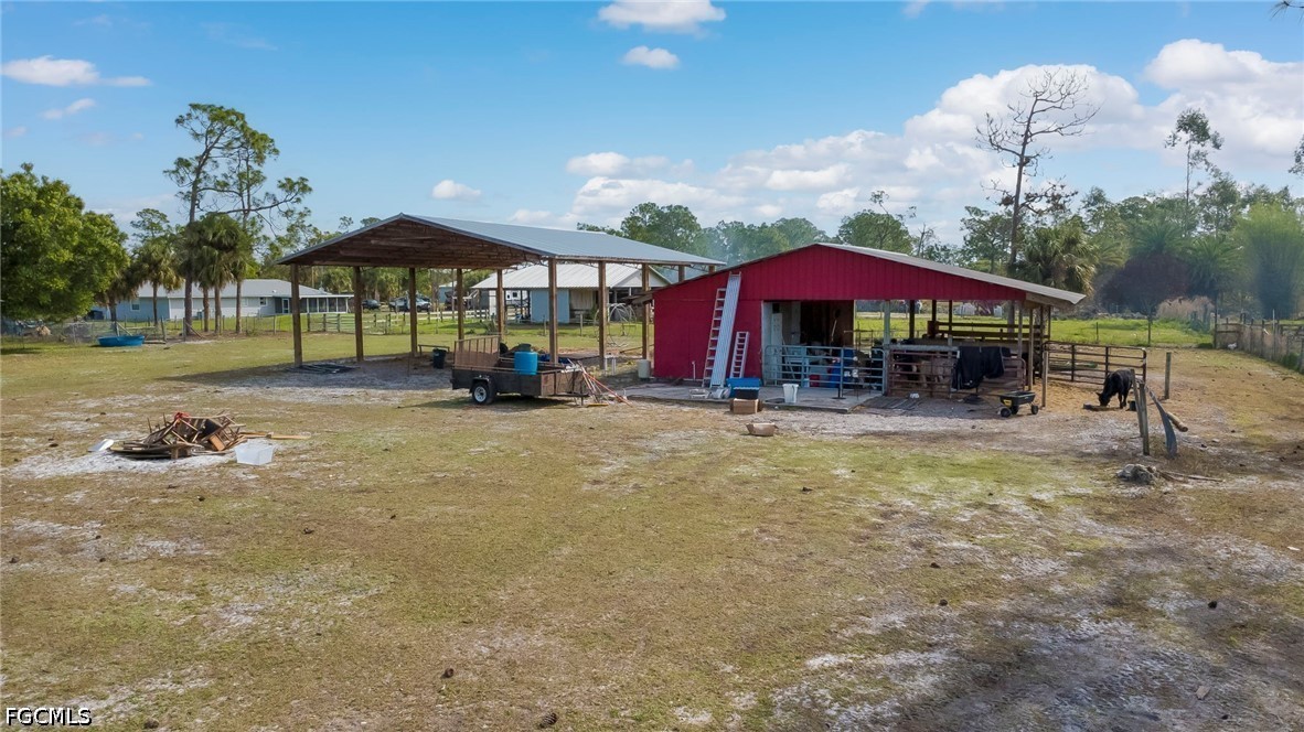 4110 East 23rd Street Alva, FL 33920 - Photo 26 of 38 a view of a house with backyard and sitting area