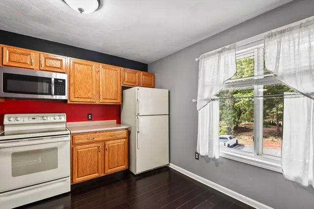 a kitchen with a refrigerator sink and cabinets