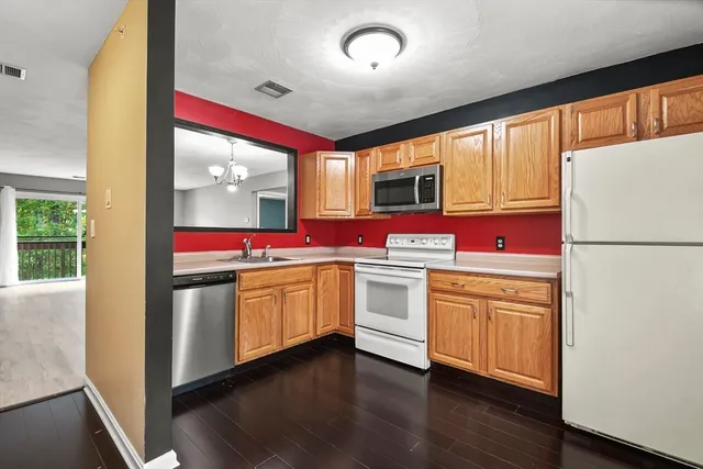 a kitchen with granite countertop appliances and cabinets