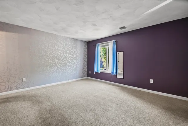 an empty room with windows and closet