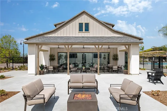 a building outdoor space with patio furniture and potted plants