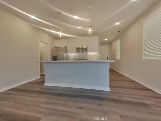 a view of kitchen with cabinets and wooden floor
