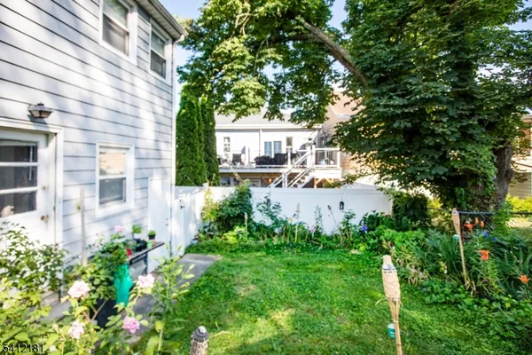 a view of a house with a yard and potted plants