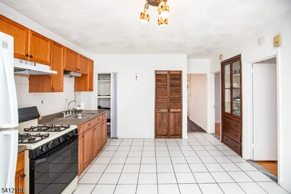 a kitchen with stainless steel appliances a stove and a refrigerator