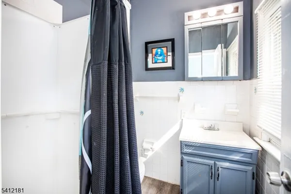 a bathroom with a sink a mirror and a shower