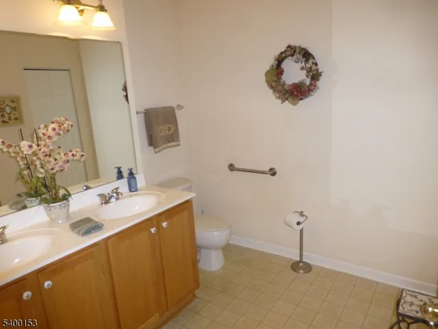 a bathroom with a sink and mirror with toilet