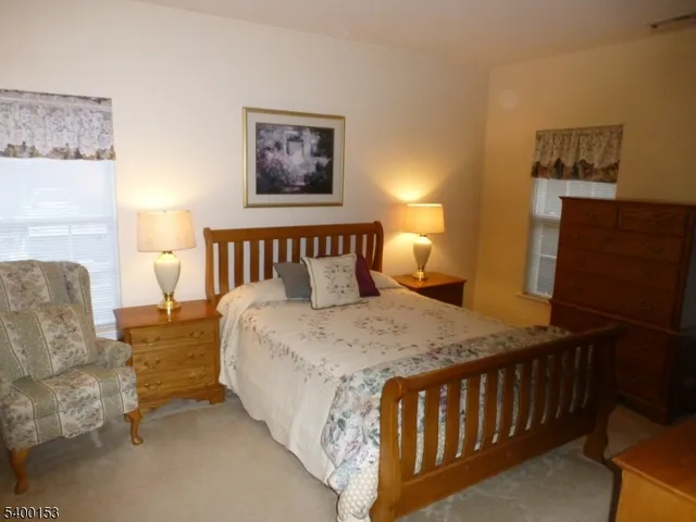 a bedroom with bed and a night stand