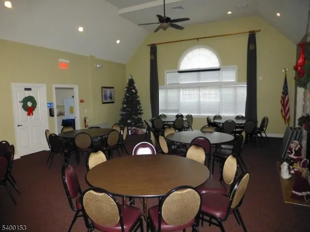 a dining room with furniture a window and wooden floor