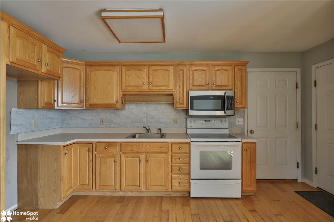 829 Georgetown Road Nazareth, PA 18064 - Photo 40 of 54 In-law suite. Ample wooden cabinetry and hardwood floors define this practical kitchen workspace.