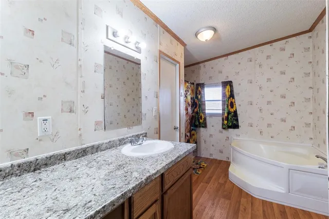 a bathroom with a granite countertop sink a toilet and shower