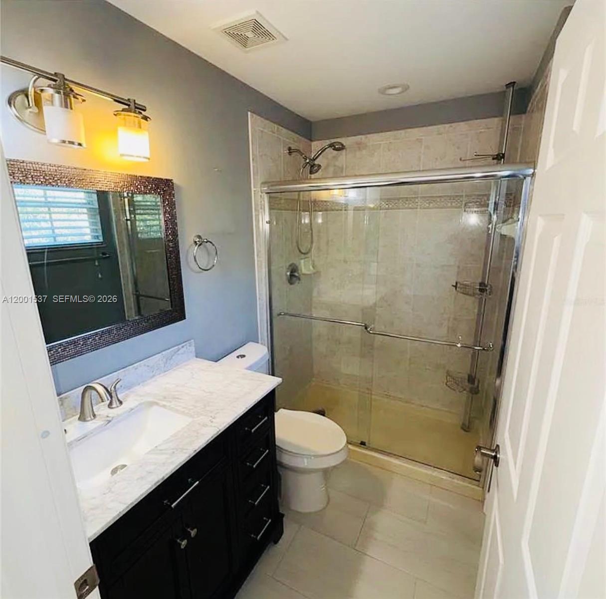 151 Coconut Key Lane Delray Beach, FL 33484 - Photo 11 of 21 a bathroom with a sink a toilet a mirror and shower