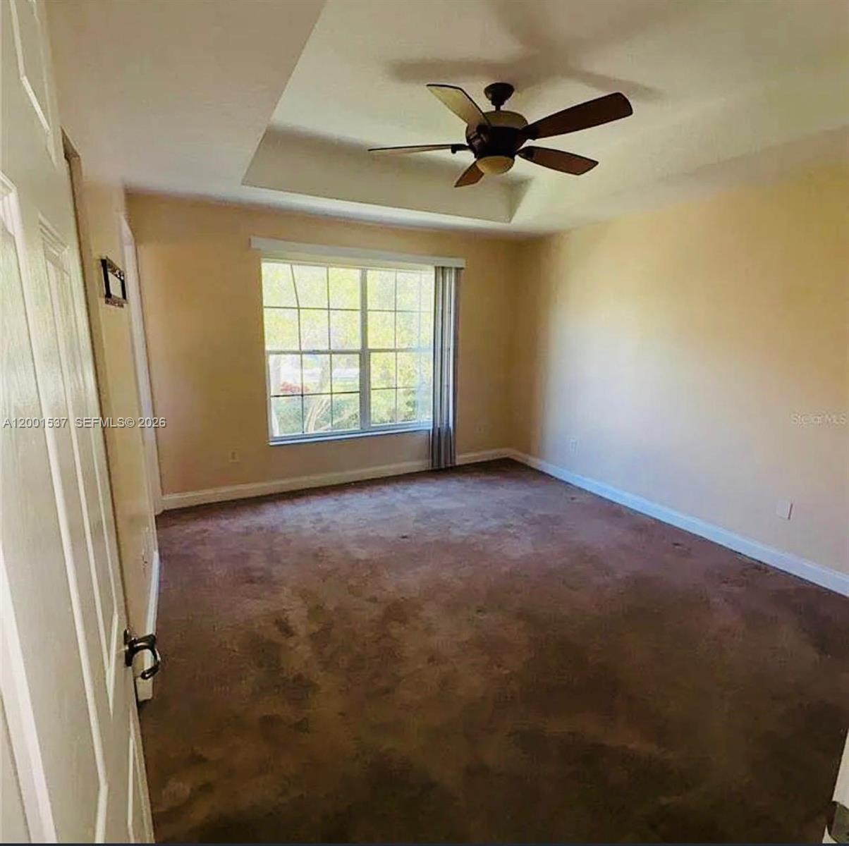 151 Coconut Key Lane Delray Beach, FL 33484 - Photo 13 of 21 an empty room with a ceiling fan and a window