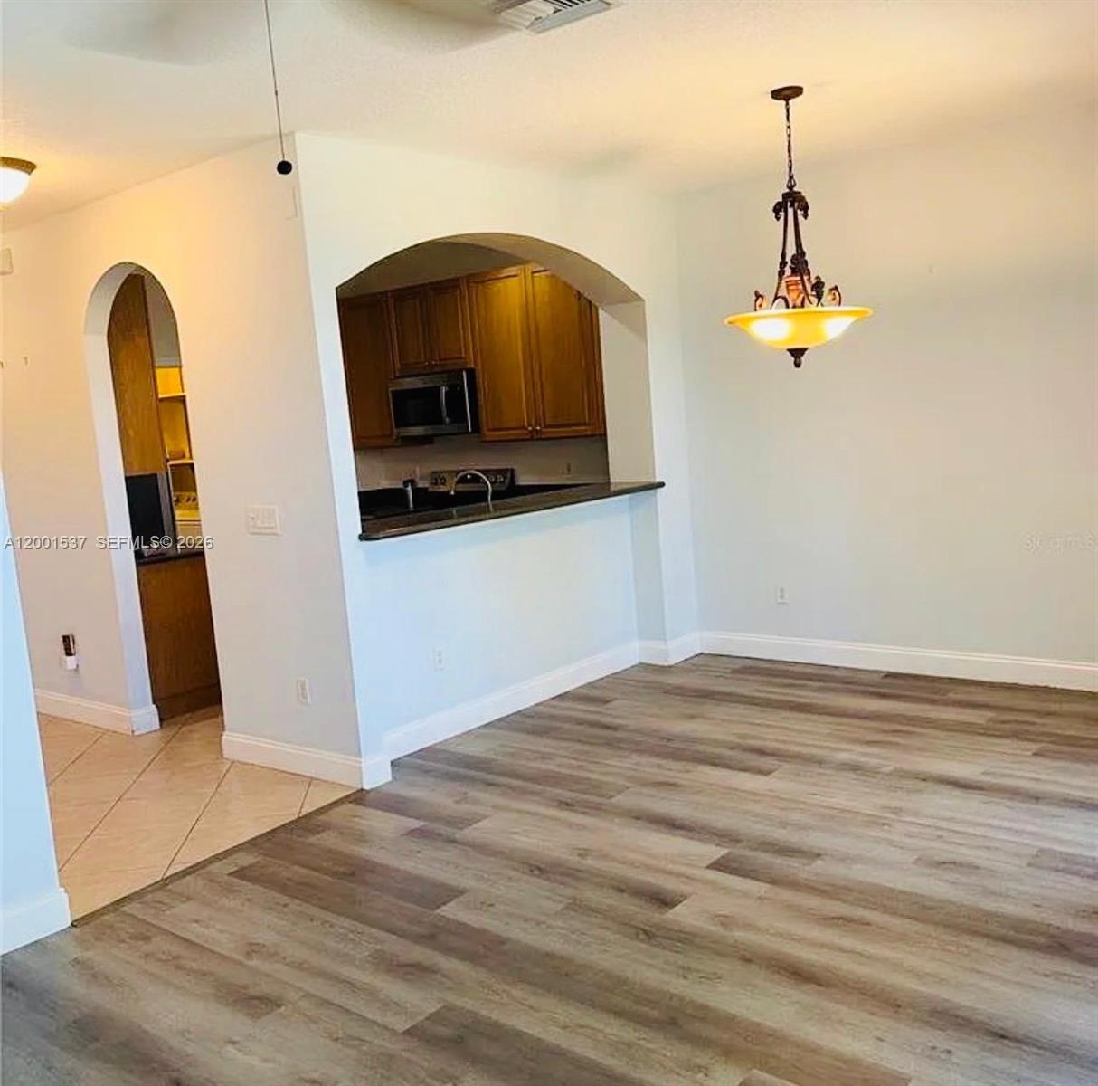 151 Coconut Key Lane Delray Beach, FL 33484 - Photo 2 of 21 a view of a living room with a flat tv screen and dresser