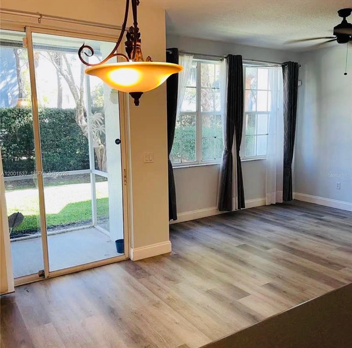 151 Coconut Key Lane Delray Beach, FL 33484 - Photo 6 of 21 a view of a room with wooden floor and windows